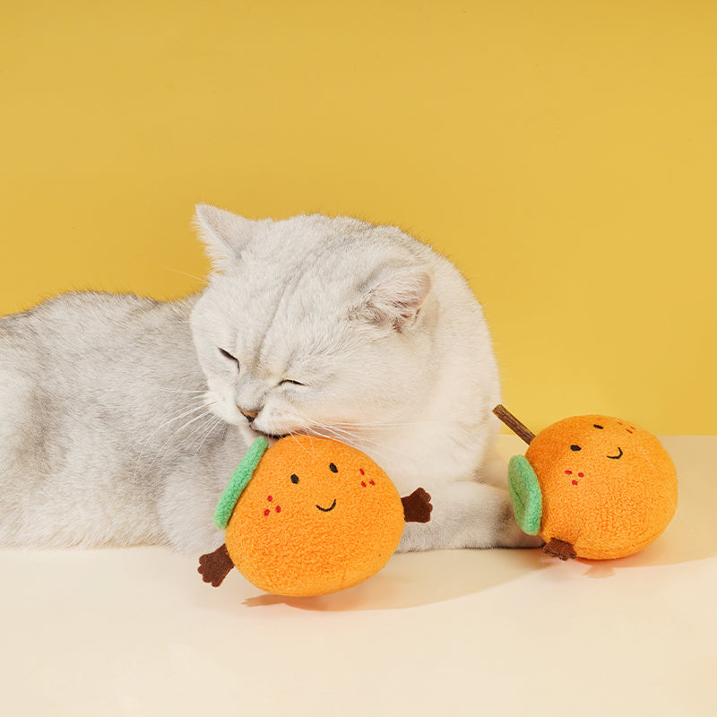 zeze plush orange cat toy with rosy cheeks, green leaf and a silvervine stick