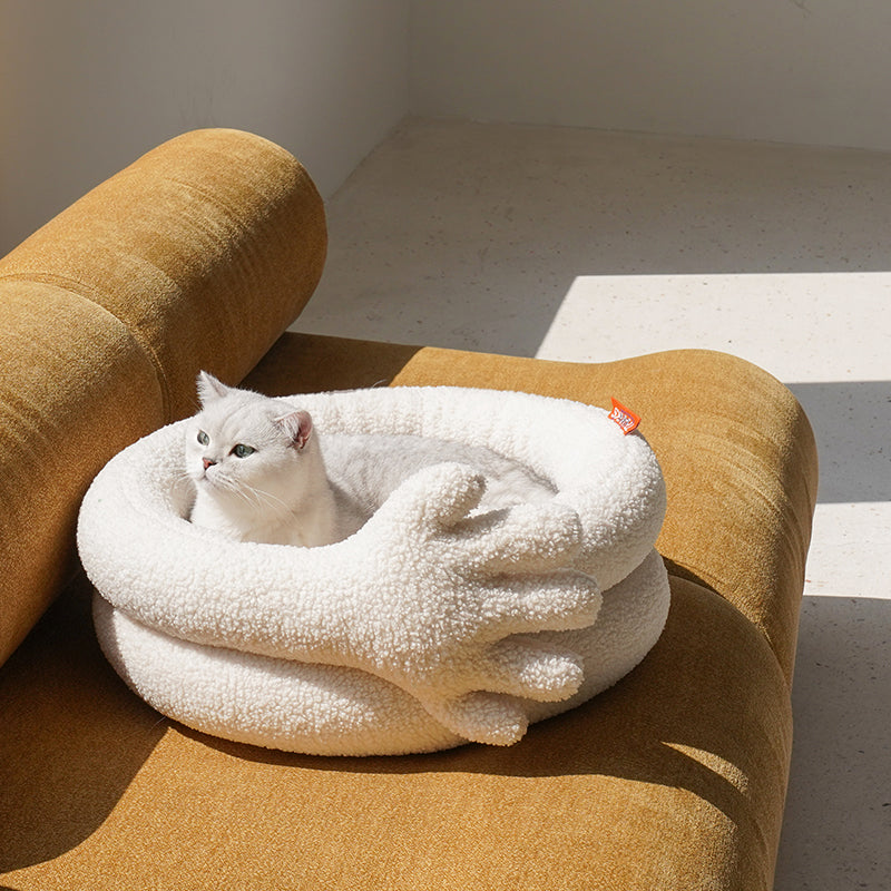 zeze Thank You Pet Bed: cream plush round bed with a large soft hand curled over the side