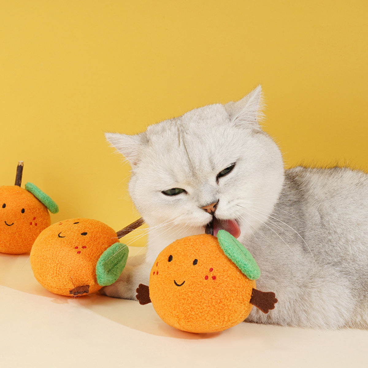 zeze Lucky Orange cat toy, cat licking the plush orange
