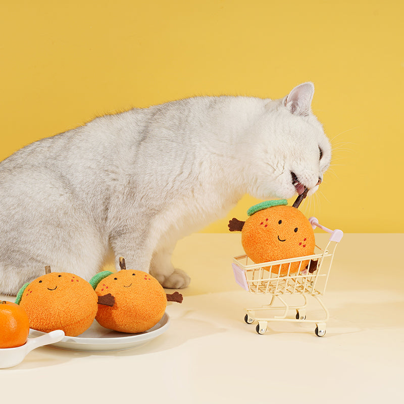 zeze plush orange cat toy with rosy cheeks, green leaf and a silvervine stick