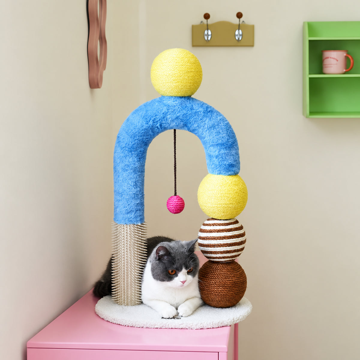 zeze Cat Arch Tree with balls and rubbing pole, customer photo on a pink cabinet with a cat
