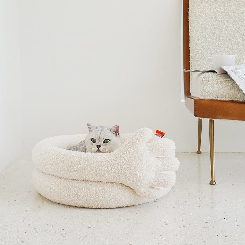 zeze Thank You Pet Bed: cream plush round bed with a large soft hand curled over the side