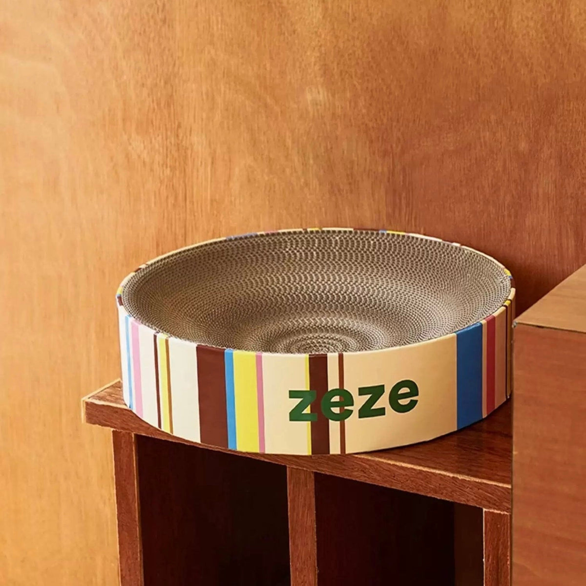 zeze Retro cat scratcher bed, Cream Mille-Feuille on a wooden shelf